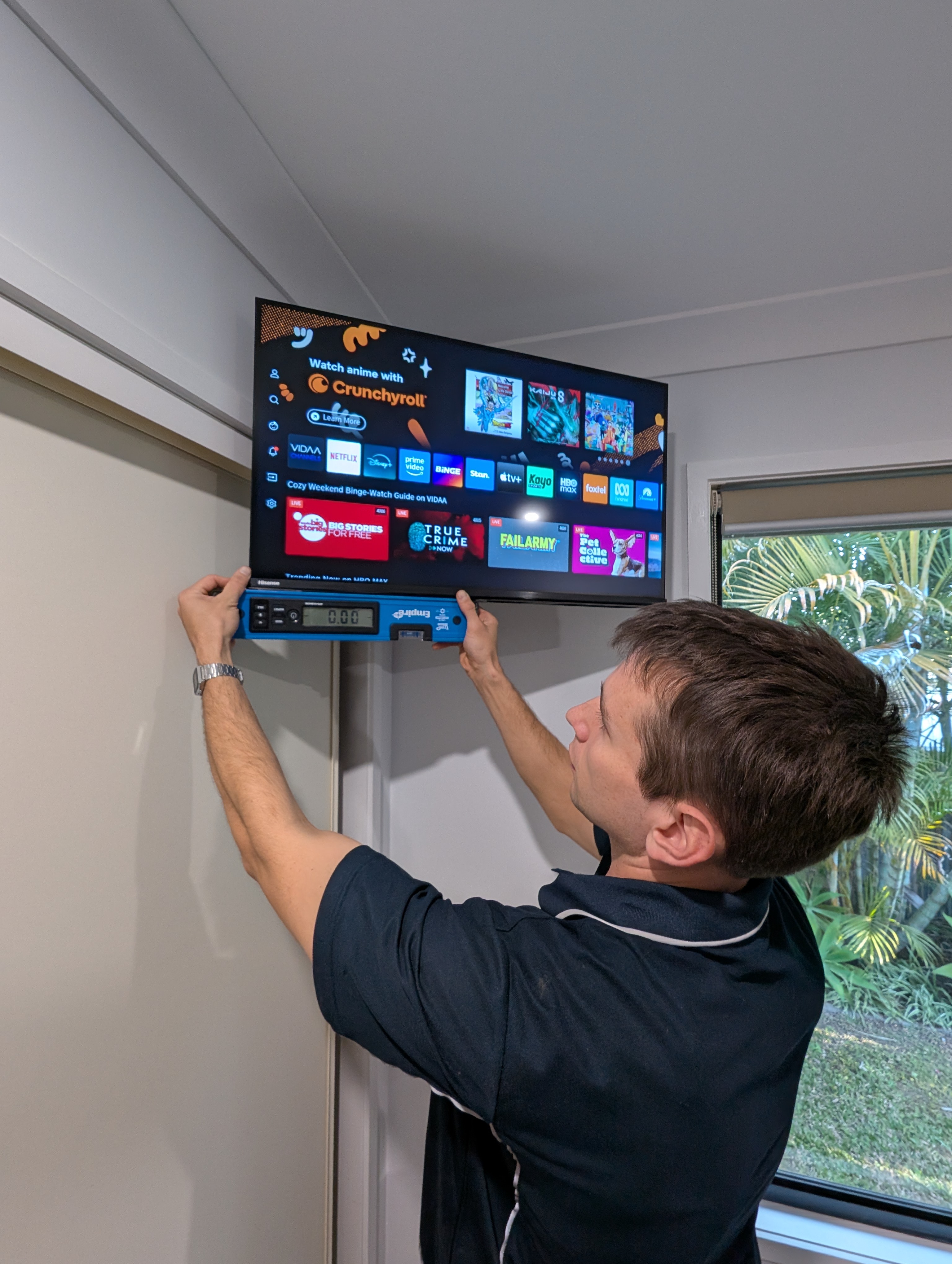Aiben levelling a corner TV on a full motion bracket.